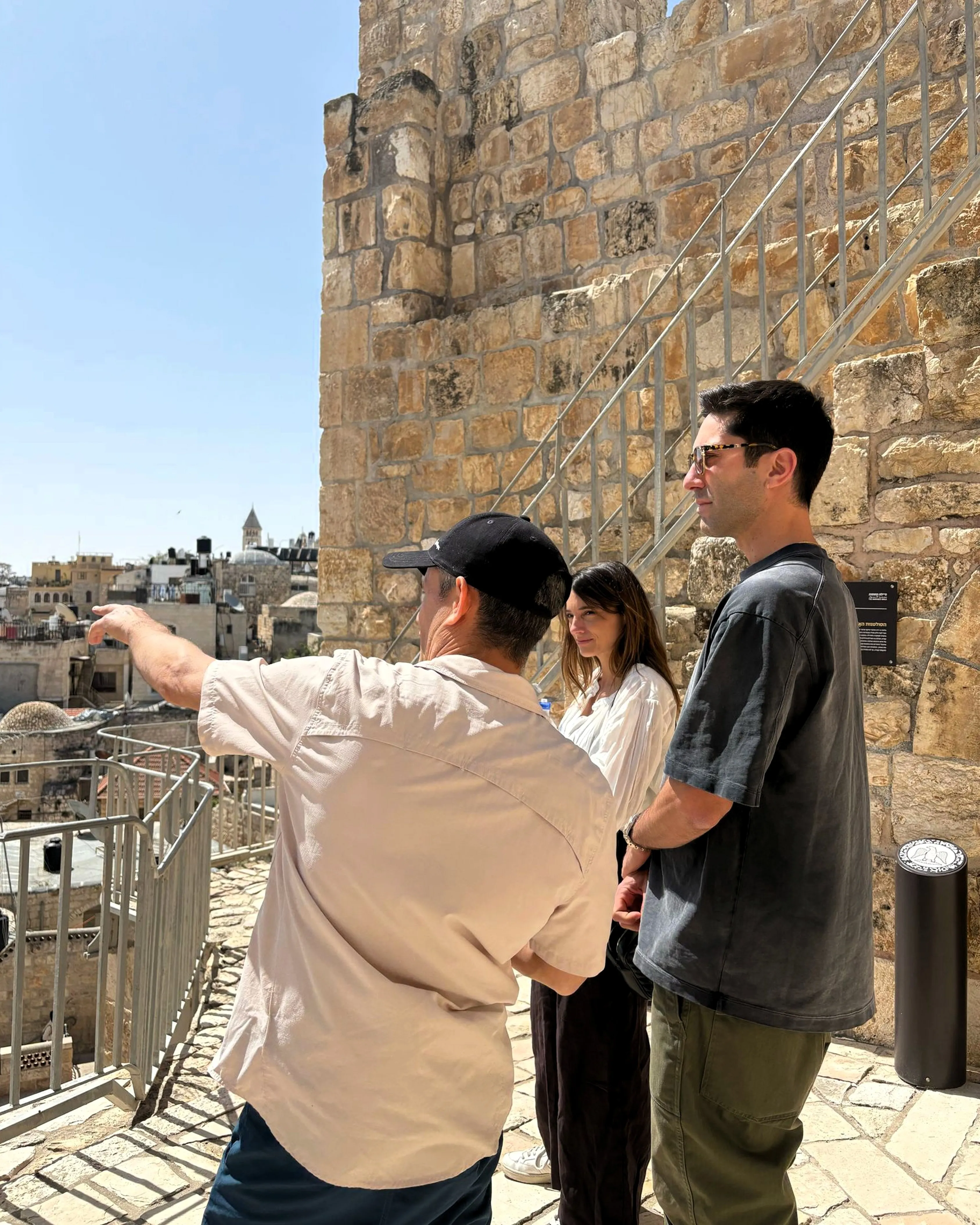 Ran Frenkel, private tour guide in Israel, showing two travelers the view over Jerusalem's Old City
